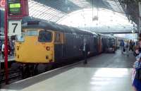 In August 1988, driver Norrie Evans of Perth walks past 26011 resting at platform 7. Beyond is a DBSO so the destination of Kings Cross is unlikely. Possibly an overnight failure at Perth taken on ECS to Dundee and then to Queen Street.<br><br>[Ewan Crawford 05/08/1988]