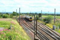 View south at Quintinshill, the site of Britain's deadliest ever rail crash. One hundred years ago this year, a multiple crash involving five trains took place here. An estimated 227 people lost their lives, the vast majority soldiers on a troop train heading for Liverpool to board a troopship bound for Gallipoli [see image 24714]. The picture shows the site in August 2015, with the passing loops still in place, although the signal box is long gone. I wonder if any passengers on Glasgow bound 350406 are aware of what happened here all those years ago.<br><br>[John Gray 11/08/2015]