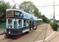 A half scale replica tram waits at Colyton, Devon, to leave on the three mile journey to Seaton. Colyton station, once one of two intermediate stops on the Seaton branch line, can be seen behind. The branch closed to trains in 1966 but was reopened for the narrow gauge trams between Colyton and Seaton in 1971.<br><br>[Mark Bartlett 01/08/2015]