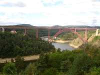 The 1884 single track Garabit Viaduct (or Eiffel Bridge) that crosses over the Tuyere river near Ruynes-en-Margeride, France, in the mountainous Massif Central region. Photographed looking west from the nearby Aire du Garabit rest area on the A75 La Meridienne auto-route in July 2015. There is a 10Kmh speed limit across the bridge following the appearance of cracks in 2009. The train service across the viaduct is now extremely sparse.<br><br>[David Pesterfield 25/07/2015]