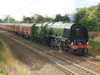 Dodging the showers, 46233 <I>Duchess of Sutherland</I> catches a brief ray of sunshine as it heads north near to the site of Boars Head Junction on the WCML whilst working the <I>Cumbrian Mountain Express</I> from Crewe to Carlisle via Settle on 15 August 2015.<br><br>[John McIntyre 15/08/2015]