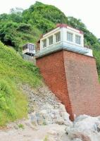 The lower station of the Babbacombe Cliff Railway sits on a sturdy stone buttress and there is a ramp for passengers to access Oddicombe Beach [see image 19532]. Viewed from below the substantial railcars seem tiny. The <I>Friends of Babbacombe Cliff Railway</I> have established an informative visitor centre on the beach which is well worth a visit.  <br><br>[Mark Bartlett 28/07/2015]