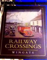 Despite the prominence of the brewer's lorry, this pub sign in County Durham seems to give a realistic view of the railway which used to cross Front Street next to this appropriately named pub. A long-term resident told me that the last use of this line was to take coal out from a nearby pit; the line closed in 1966. One pair of gates, and both pairs of gate posts, survive.<br><br>[Ken Strachan 12/07/2015]