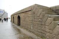 In the left background members of the GNoSR Association stand on the trackbed of the South Breakwater railway at Peterhead Harbour of Refuge on 20 June 2015. In the foreground is clear evidence of Admiralty design standards, attention to detail and exceptional craftsmanship in the granite construction of the breakwater walls. Thanks are due to Admiralty civilian Engineers, stone-masons and convict labourers.<br><br>[Brian Taylor 20/06/2015]