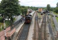 View over Buckfastleigh station from the footbridge, looking towards Ashburton on 26 July 2015. GWR 0-6-0PT 5786, running in London Transport maroon livery as L92 [see image 17855], is waiting to depart for Totnes. Further items of Dart Valley stock can also be seen in various sidings.    <br><br>[Mark Bartlett 26/07/2015]