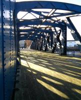 The Victoria Swing Bridge crossed the Water of Leith almost at its mouth and provided rail connection between the various docks on either side. Now it is a pedestrian bridge linking smart flats and eateries with, well, other smart etc. Caught at the right moment in late winter sunshine this image makes an admired screensaver. Just saying.<br>
<br><br>[David Panton 28/02/2015]