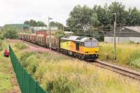 The Sunday <I>log empties</I> from Chirk to Carlisle run through Woodacre behind Colas 60087 on 9th August 2015. Following a recent fatality at this location contractors were mid-way through installing a green palisade fence along the east side of the line.<br><br>[Mark Bartlett 09/08/2015]