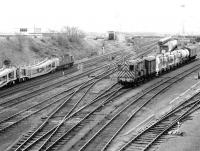 A Busy looking Millerhill yard on 10 April 1981. On the left 27106 is arriving from the north with empty Cartics, while on the right 08720 is shunting the down sidings. [See image 52385]<br><br>[John Furnevel 10/04/1981]