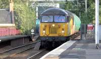 Colas Railfreight 56078, working the 4N47 Prestwick Airport to Ineos Grangemouth empty aviation fuel tanks, runs north through Coatbridge Central on 14 July 2015.<br><br>[Ken Browne 14/07/2015]