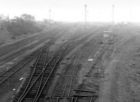 Looking south over Millerhill Yard on a misty 28 April 1984. Tracklifting is well underway, with the down sidings being removed. [See image 52371]<br><br>[Bill Roberton 28/04/1984]