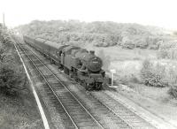 A view from the East Kilbride line of 42144 near Williamwood on 17 May 1960 with the 5.24pm Glasgow Central to Whitecraigs train. The embankment in the background carries the spur from Muirend to Clarkston East Junction. [Ref query 6879]<br><br>[G H Robin collection by courtesy of the Mitchell Library, Glasgow 17/05/1960]