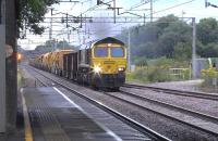 Freightliner Heavy Haul 66957 working hard with 6X04, an engineers works train From Crewe, southbound through Acton Bridge on 27 July 2015 heading for Atherston. 66595 is bringing up the rear. [Ref query 6610]<br><br>[Ken Browne 27/07/2015]