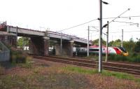 The 1440 Glasgow Central - Euston Pendolino passes under the partly constructed Old Mill Road bridge across the WCML at Cambuslang on 28th August 2015. The rebuilt bridge is due to open at the end of October 2015 [see image 51404].<br><br>[Colin McDonald 28/08/2015]