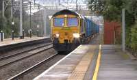 The Northenden to Folly Lane (Runcorn) '<I>Binliner</I>' containers, heading north through Acton Bridge on 27 July 2015 behind Freightliner 66551.<br><br>[Ken Browne 27/07/2015]