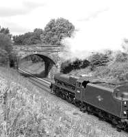 At about 13:35 on 20 August 2015 Jubilee No. 45699  accelerates away from the water stop at Appleby while working the northbound Dalesman. <I>Galatea</I> will shortly pass under the highly skewed masonry arch bridge at Brown Bank, which now carries no more than an unsurfaced farm track over the line. The track was at one time part of the Penrith to Brough Roman road and one presumes must have retained some importance into more recent times to justify such an expensive form of bridge construction.<br><br>[Bill Jamieson 20/08/2015]