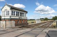 The signalbox at Alrewas, which controls a level crossing on a minor road, marks the start of a short single line section on the line from Lichfield to Wichnor Junction. The station at Alrewas was just behind the camera but all trace has been removed since its closure in 1965. The line is now used for freight movements and also by Voyagers running to and from the nearby Barton-under-Needwood depot. [Ref query 34665] <br><br>[Mark Bartlett 28/08/2015]