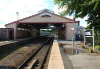 The outstanding Frome station, with its wooden train shed still protecting passengers from the elements. View west along the surviving platform in July 2015. The associated buildings are in equally good condition [See image 51440]. <br><br>[Mark Bartlett 25/07/2015]