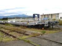 The end vehicle in a line of new articulated LOHR Industries piggyback wagons stabled in the former small yard at St-Jean-Pla-de-Corts in the Pyrenees-Oriental region on the branch line to Ceret. <br><br>[David Pesterfield 01/08/2015]