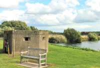 DBS 66140 runs light engine towards Tamworth on 28 August, passing a <I>pillbox</I> in the grounds of the National Memorial Arboretum. The locomotive is crossing the River Tame to the south of Wichnor Junction.<br>
<br>
<br><br>[Mark Bartlett 28/08/2015]