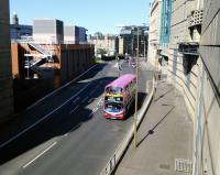 In a sort of irony the reintroduction of trains from Waverley to the borders happened on the 50th anniversary of the closure of Edinburgh's other main terminus, Princes Street.  There's little to see at the site, but a few years after closure the trackbed was converted to a useful urban fastway. Scene from Morrison Street bridge looking towards the station site on 6 September 2015. A pink-topped No 22 bus is in shot. Visiting comedian Mark Steel's estimation of one every ten seconds is not far off target.<br>
<br><br>[David Panton 06/09/2015]