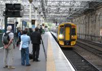 The first 'public' train from Tweedbank to Edinburgh – the Golden Ticket special from Tweedbank pulls into Waverley bang on time at 12.29 on Saturday 5th September, closely watched by a fim crew and (far left) rail campaigner and Railscot contributor Bill Jamieson.<br><br>[David Spaven 05/09/2015]