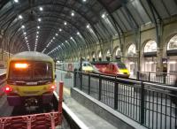 Contrasts at the Cross on 2nd September. The HST on the right has just arrived, while the 365 on the left is ready to go. Meantime a DVT is heading out between them. There is quite a difference in the amount of red livery on the Virgin DVT and HST power car.<br><br>[Ken Strachan 02/09/2015]