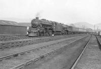 A down West Highland train coasts through Dumbarton East Junction on 12 April 1958. Locomotives are Black 5 44973 and K2 61787 <I>Loch Quoich</I>.  <br><br>[G H Robin collection by courtesy of the Mitchell Library, Glasgow 12/04/1958]