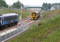 An east coast haar is just starting to lift as a train from Tweedbank approaches Shawfair from the Sheriffhall direction on 8 September and is about to pass a service heading south.<br><br>[John Furnevel 08/09/2015]