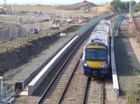 Waverley bound 170472 passes the well advanced platforms of Edinburgh Gateway train/tram interchange on 8 September 2015. Edinburgh Airport control tower is visible in the left background.<br><br>[Bill Roberton 08/09/2015]