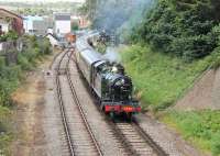 GWR 2-8-0T 5239 leaves Paignton heading for Kingswear with another heavy train on the Paignton and Dartmouth Railway in July 2015. The line on the left is still operated by Network Rail and gives access to Goodrington Carriage Sidings. The crossover beneath the second carriage is the link between the two railways allowing through running of special excursions. <br><br>[Mark Bartlett 28/07/2015]