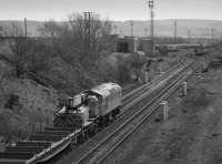 26027 approaches with an engineers train.  The Waverley Route main line has been severed with a modified connection (at 'Millerhill Yard Junction') into the Up Yard.<br><br>[Bill Roberton 13/04/1988]