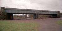 With the remains of Dundyvan Basin and the still open Monkland and Kirkintilloch 'mainline' behind, this was the view looking west in 2001 where the Monkland and Kirkintilloch's branch to Dundyvan Iron Works and Souterhouse passed under the Caledonian line. Dundyvan Iron Works' blast furnaces were just beyond the bridge, which today is a housing estate. Much of the branch is now a footpath and a bridge remains over Dundyvan Road immediately adjoining the Rutherglen and Coatbridge's Langloan to Coatbridge Junction curve.<br><br>[Ewan Crawford //2001]