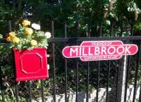 Things to do at Millbrook: 1) Assure a concerned passenger that she hasn't missed her train for Bedford - it will depart from the other platform; 2) look through the hedge (too thick to allow photography) of the guards van at right angles to the line; 3) enjoy the platform decorations on the Bletchley bound platform.<br><br>[Ken Strachan 10/09/2015]