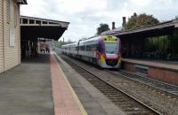 A southbound for Melbourne pulls in, passing a northbound train. <br>
The northbound one has the new branding with V/Line on the doors but PT> on the nose, while one seen here has V/Line on its nose.<br>
PT> is slowly being applied to them all.<br><br>[Colin Miller 01/10/2014]