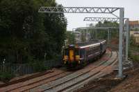 The pointwork for the new connection to the main line has still to be laid as the 1246 arrival from Glasgow Queen Street  approaches Anniesland on 23rd September 2015. The newly installed cantilever supports for an OHLE overrun at the junction caused some premature excitement recently when rumours of an electrification of the Maryhill line began to circulate.<br><br>[Colin McDonald 23/09/2015]