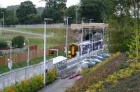 Looking back towards Newtongrange station on 14 September 2015 from the pedestrian pathway linking the car park to the Scottish Mining Museum. The 0853 Edinburgh - Tweedbank has just arrived at the platform on what was a dark and dreary morning [see image 52642].<br><br>[John Furnevel 14/09/2015]