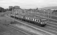 A class 303 leaves Yoker Depot sidings on 16 September 1988.  In the foreground is the reinstated Rothesay Dock branch.<br><br>[Bill Roberton 16/09/1988]