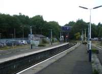 The west end of Wigan Wallgate is crossed by the West Coast Main Line, on which a passing train can be seen in the distance. View looks west.<br><br>[Veronica Clibbery 17/09/2015]
