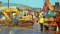 The damaged front end of the train which demolished Largs station can be seen between the two G&D Cunningham vehicles.<br><br>[Ewan Crawford 11/07/1995]