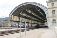 Although Portbou only has a population of arond 1300 it is the change of gauge border point where the SNCF meets the RENFE and the station buildings are huge. A Class 447 EMU, waiting to return towards Barcelona, is dwarfed by the trainshed. The busy freight yards can be seen beyond the platforms. <br><br>[Mark Bartlett 22/09/2015]