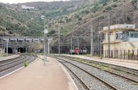 View south from the long platforms at Cerbere towards the 1km tunnels that lead to Portbou in Spain. The RENFE shunter 311.131 will have worked a transfer freight through. The white building near the top of the hill is the old Franco-Spanish border post, now disused, on the 7km zig-zag road between the two towns. <br><br>[Mark Bartlett 22/09/2015]