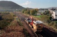 A trolley heads from Tom-na-faire depot with pipes to be laid below Fort William Junction Yard.<br><br>[Ewan Crawford //1995]