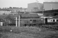 Seen from a train on the WCML, 31449 waits for entry into Carlisle with a service off the Settle and Carlisle line.  In the background is the NEI Cowans Boyd (formerly Cowans Sheldon works) with a crane in the forecourt. Now a retail park.  2 May 1986.<br><br>[Bill Roberton 02/05/1986]