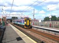 ScotRail 156513, still in National Express livery, arrives at Whifflet on 24 August 2006 with a mid-afternoon Cumbernauld - Motherwell train. Stabled on the right behind the platform on the Whifflet South - Sunnyside Junction line is 156513, which will form the next service to Glasgow Central. <br><br>[John Furnevel 24/08/2006]