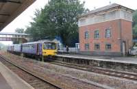 A four car FGW Class 143 Pacer set slows for the Torre stop on a Paignton to Exmouth Sunday working. The tall, but now redundant, signal box dominates the Up platform.<br><br>[Mark Bartlett 26/07/2015]