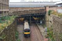 320310 enters Glasgow Queen Sreet Low Level with a westbound service on 7 October 2015. The roof of the high level station dominates the background.<br><br>[John McIntyre 07/10/2015]