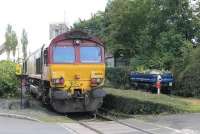 A <I>Gate Guardian</I> has been installed at the entrance to the Castle Cement works in the form of an old quarry wagon, mounted on a short length of track. The new feature is seen here alongside DBS 66054, which had arrived from Mossend and was shunting its train under the loading facility.<br><br>[Mark Bartlett 07/08/2015]