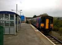 As Melksham is the fifth largest town in Wiltshire, it was unfortunate that the town station was closed and largely demolished in 1966. However, it was reopened in 1985, using about a third of one original platform. Services were increased from two per weekday to eight from December 2013. With its load lightened by some twenty passengers, the 18.02 to Swindon (originating at Westbury, and comprising single unit 153.370) sets out towards Chippenham on 10th October. [See image 48597]<br><br>[Ken Strachan 10/10/2015]