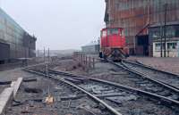 DH9 between jobs at Dalzell Steelworks in 1988. This gritty location was a lunchtime favourite of mine. The line to the left ran to the extensive scrapyards between Ravenscraig (RG) and Dalzell (DL) and was also used for delivery of steel slabs from RG to DL for rolling. The locomotive is on the line which rose up to the works. Behind the camera is a reversing spur. These tracks were lifted with the closure of RG and the approach to DL from the mainline just to the south of Motherwell station brought back into use.<br><br>[Ewan Crawford //1988]