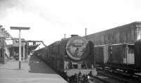 The combined 1.5pm ex-Manchester, 1.10pm ex-Liverpool calls at Carlisle on 17 July 1965. The train will split at Carstairs into portions for Glasgow Central and Edinburgh Princes Street. On the front of the train is Britannia Pacific 70041 <I>Sir John Moore</I>, although the reporting code 1P22 displayed on the locomotive's smokebox is from a previous working.<br><br>[K A Gray 17/07/1965]